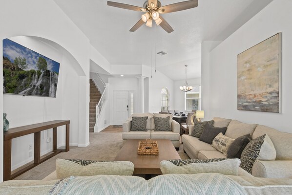 Relax in this inviting living area with a sofa, coffee table, and wall art.