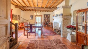 Un intérieur rustique avec des poutres apparentes, une cheminée et des meubles traditionnels.