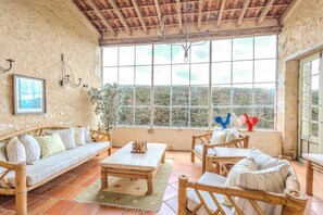 Une pièce au décor rustique, dotée d’une grande fenêtre, de meubles en bois et offrant une vue sur l’extérieur.