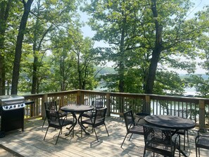Enjoy a serene lake view from this deck, complete with a grill and seating for four.