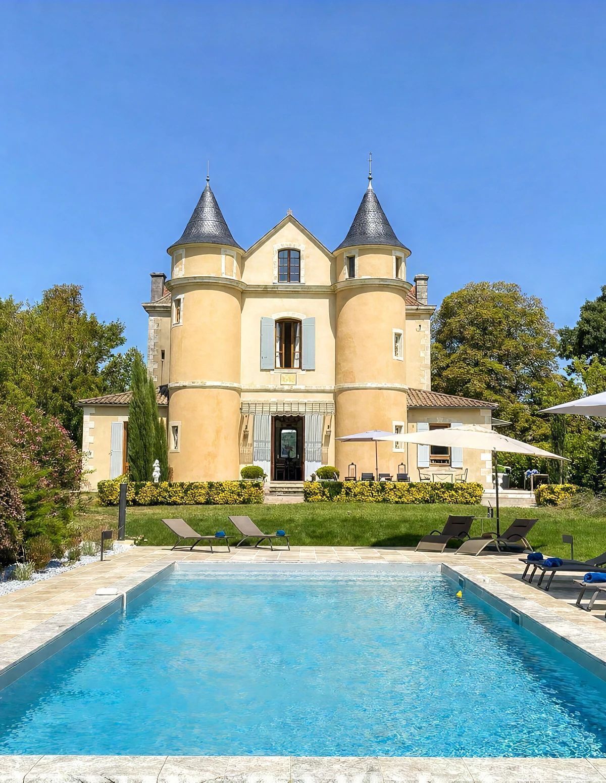 A large building with a swimming pool in front.