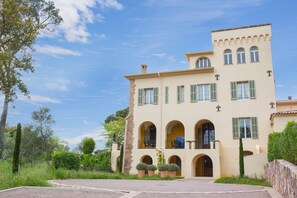 A two-story building with a symmetrical facade, multiple windows with shutters, and a central balcony. - Villa Amalie - Fifteen Bedroom Villa, Sleeps 32 (Saint Raphael)