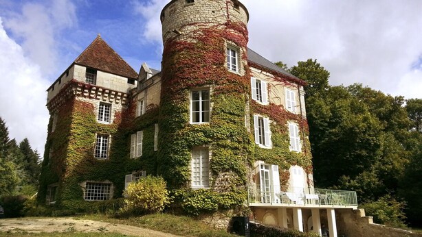 A castle-like building with a tower, ivy-covered walls, and a balcony. - Chateau Roussignol - Twelve Bedroom Castle, Sleeps 28 (Le Blanc)