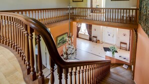 A multi-level wooden staircase with a curved design, connecting two floors.