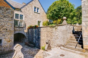 A stone building with a stone staircase and a small balcony. - Chateau Alois - Fourteen Bedroom Castle, Sleeps 35 (Ciney)