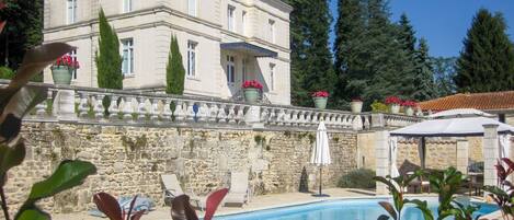 A heated pool, sun loungers