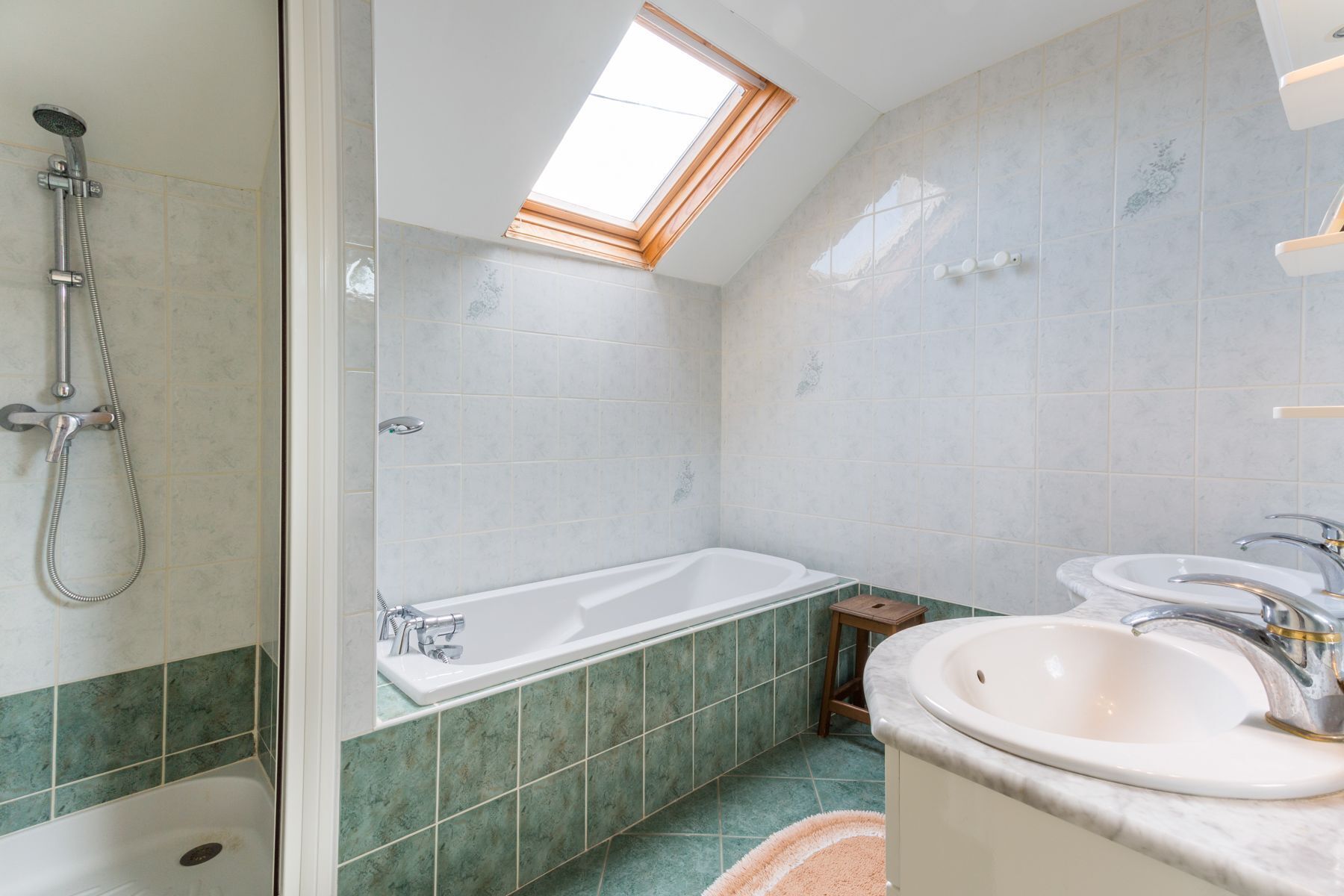 A bathroom with a shower, a bathtub, and a sink.