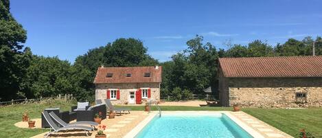A heated pool, pool loungers