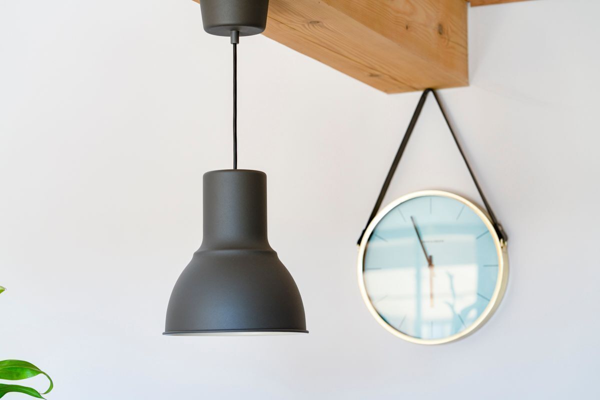 A pendant light and a wall clock.