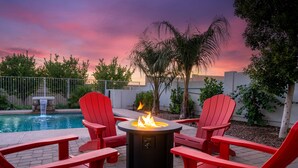A patio with a fire pit, red Adirondack chairs, and a pool. - BILTMORE BLISS→Rooftop w/ Mountain/City View, Pool (Phoenix)