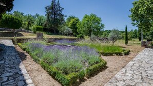 A garden with lavender, stone pathways, and various trees. - Mas Des Collines - Six Bedroom Villa, Sleeps 12 (Saignon)
