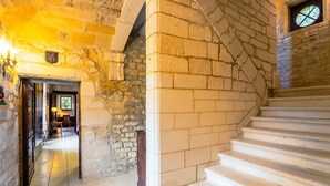 A stone staircase leading to a lower level, with a view of a room with a window and a door at the top. - Manoir 1731 - Six Bedroom Villa, Sleeps 12 (Carlux)