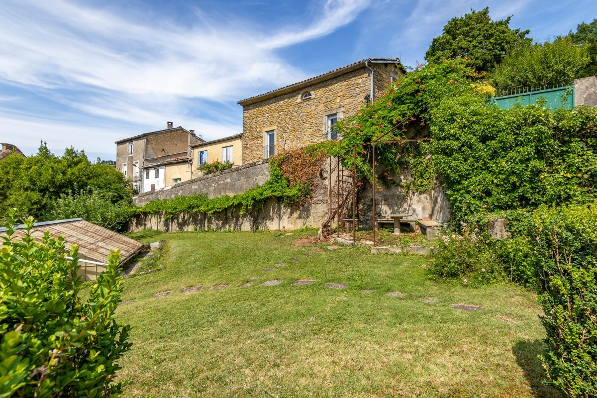 A stone building with a garden in front.
