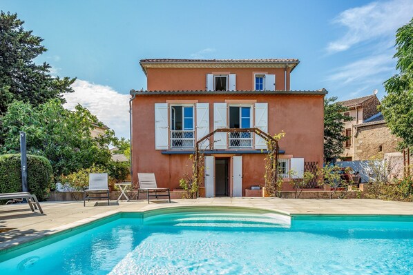 A two-story building with a swimming pool in front. - Villa Du Midi - Four Bedroom Villa, Sleeps 8 (Cruzy)