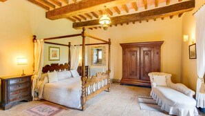 A traditional bedroom with a four-poster bed, a wooden cabinet, and a bench. - Castello Gubbio - Fifteen Bedroom Castle, Sleeps 30 (Gubbio)