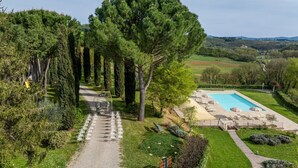 A landscaped garden with a pool, a clear path, and a seating area.