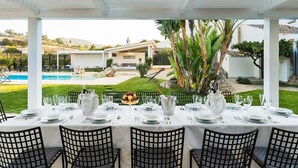 A covered outdoor dining area with a view of a pool and a house. - Gia Costa - Eight Bedroom Villa, Sleeps 16 (Buseto Palizzolo)