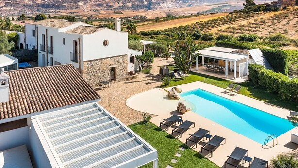 A modern villa with a swimming pool, outdoor seating, and a view of the surrounding landscape. - Gia Costa - Eight Bedroom Villa, Sleeps 16 (Buseto Palizzolo)