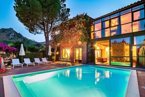 A heated pool, sun loungers