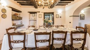 A dining room with a wooden ceiling, white tablecloths, and wooden chairs. - San Veriano - Five Bedroom Villa, Sleeps 10 (Ripoli)