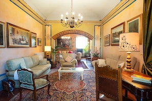 A traditional living room with a chandelier, sofas, armchairs, and a patterned rug. - Tenuta Bartolucci - Ten Bedroom Villa, Sleeps 22 (Palaia)