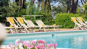 A pool area with lounge chairs and yellow towels. - Tenuta Bartolucci - Ten Bedroom Villa, Sleeps 22 (Palaia)