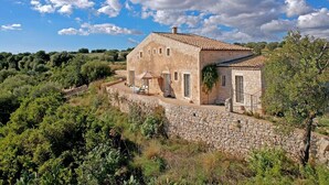 A stone house with a tiled roof, surrounded by greenery and a stone wall. - La Picca Estate - Six Bedroom Villa, Sleeps 12 (Scicli)