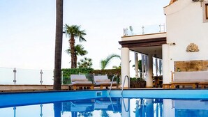 A clear blue pool with lounge chairs and a palm tree, reflecting the sky. - Villa Naxos - Eight Bedroom Villa, Sleeps 18 (Taormina)
