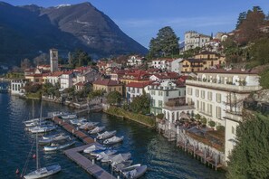 A coastal town with a marina, historic buildings, and a prominent church tower.