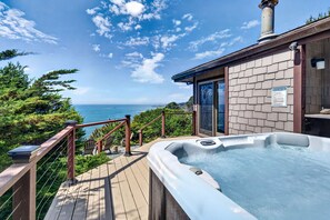 A hot tub on a wooden deck with a view of the ocean. - Pet-friendly Oceanfront Retreat w/King Beds & Hot Tub! (Gualala)
