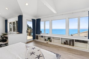 A bedroom with a large window, a bed, a desk, and a chair. - Pet-friendly Oceanfront Retreat w/King Beds & Hot Tub! (Gualala)