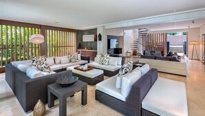 A modern living room with a sofa set, a coffee table, and a TV. - Villa Lily Pad - Three Bedroom Villa, Sleeps 6 (Gibbes)