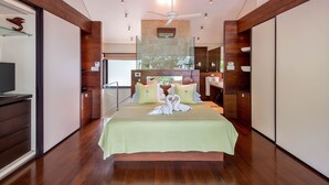 A hotel room with a bed, a television, a desk, and a bathroom. - Villa Lily Pad - Three Bedroom Villa, Sleeps 6 (Gibbes)
