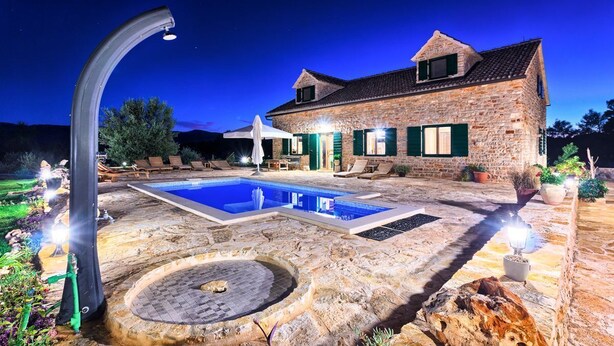 A stone house with a swimming pool, outdoor seating, and a fire pit. - Old Town Villa Hvar - Five Bedroom Villa, Sleeps 12 (Uvala Tatinja)