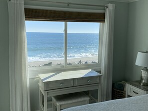 Enjoy ocean views from the large window, work at the desk with drawers, and relax by the bedside lamp.