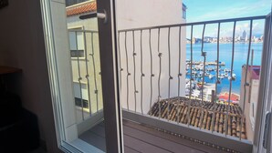 A balcony with a view of a marina and city skyline. - Hotel Clopy Rocamar (Benidorm)