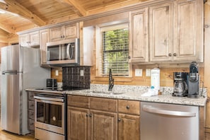 Enjoy cooking in this well-equipped kitchen with a double oven, microwave, dishwasher, and coffee maker.