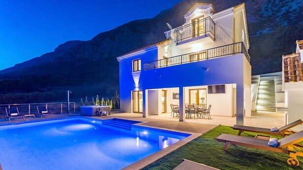 A modern two-story house with a swimming pool, outdoor seating, and a mountain backdrop. - Villa Nedy - Four Bedroom Villa, Sleeps 8 (Zakucac)