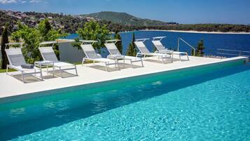 An infinity pool, pool loungers