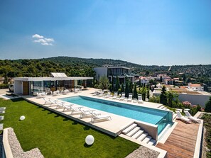 An infinity pool, pool loungers