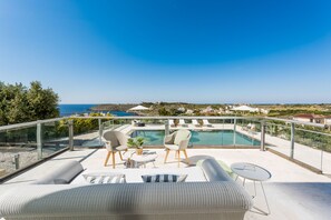A rooftop terrace with a pool, seating area, and a view of the coastline. - Sea View Villas - Four Bedroom Villa, Sleeps 8 (Chania)