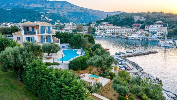 A coastal property with a swimming pool, marina, and mountainous backdrop. - Villa Aliki - Five Bedroom Villa, Sleeps 10 (Kassiopi)