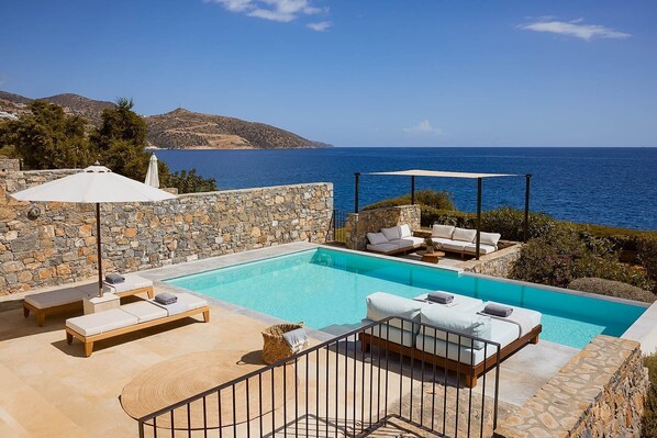 An infinity pool, a heated pool, pool loungers