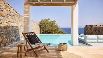 An infinity pool, a heated pool, sun loungers