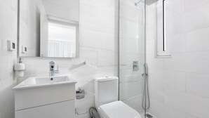 A modern bathroom with a glass shower enclosure, a white sink, and a toilet. - Villa Constantine - Six Bedroom Villa, Sleeps 15 (Kolympia)
