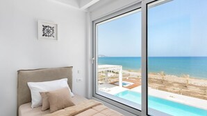 A bedroom with a large window overlooking a pool and the sea. - Villa Constantine - Six Bedroom Villa, Sleeps 15 (Kolympia)