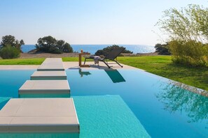 An infinity pool, sun loungers