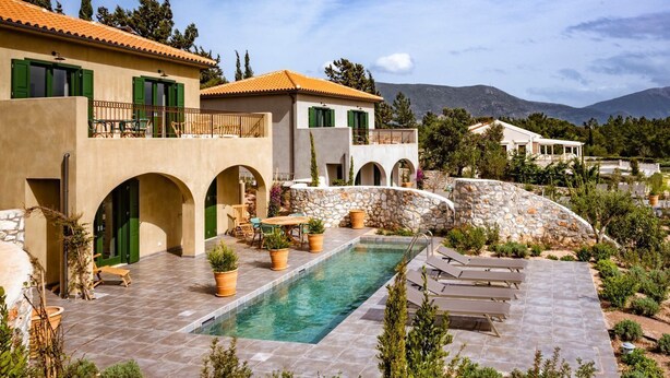 A Mediterranean-style villa with a swimming pool, outdoor seating, and a stone wall. - Villa Drosoula - Two Bedroom Villa, Sleeps 4 (Fiskardo)