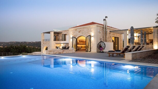 A modern villa with a swimming pool, outdoor seating, and a view of the landscape. - Villa Armenoi - Three Bedroom Villa, Sleeps 8 (Apokoronos)
