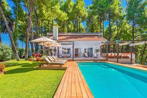 A heated pool, sun loungers